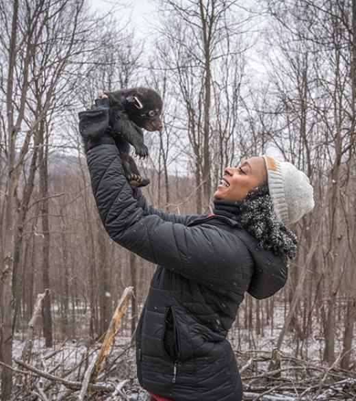 Rae Wynn-Grant with bear cub